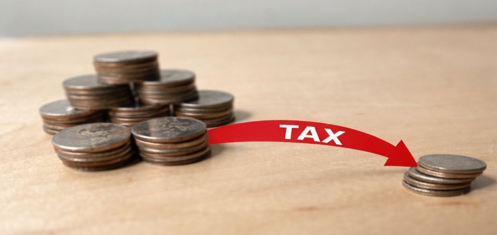 A single stack of coins set apart from asset coins — a quiet image of what gets separated out when inheritance tax is owed.